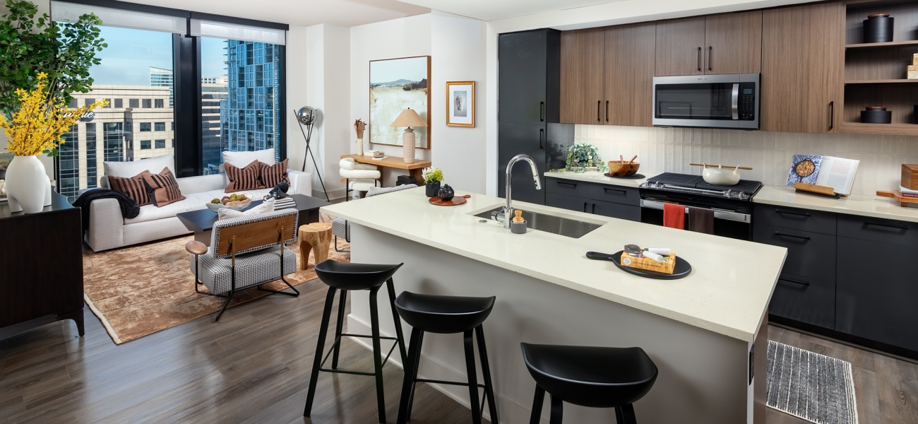 open concept living area kitchen island cabinetry large windows city views open concept living area kitchen island cabinetry large windows city views
