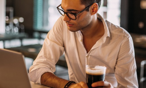 man sitting laptop drink glasses button up shirt
