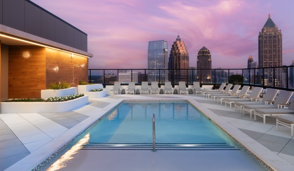 nomia rooftop pool city skyline skyscrapers sundeck chaise loungers