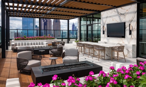 nomia midtown rooftop terrace fire table seating bar tv city views